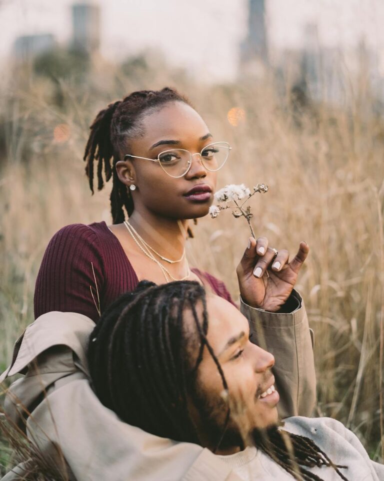 man and woman surrounded by grass